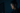 woman looking at computer screen, in a dark room